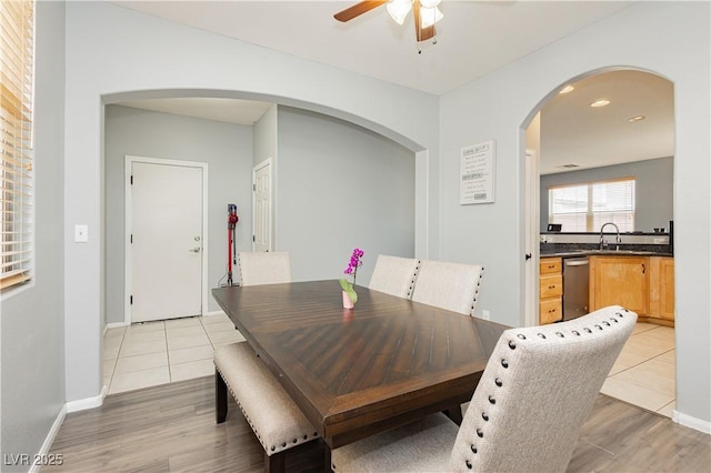 561 Fork Mesa Ct, Henderson, NV 89015 - dining room featuring a ceiling fan, light wood-style flooring, arched walkways, baseboards, and recessed lighting