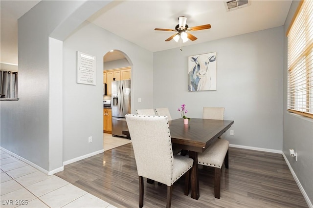 561 Fork Mesa Ct, Henderson, NV 89015 - dining space featuring arched walkways, ceiling fan, light wood-style floors, and baseboards