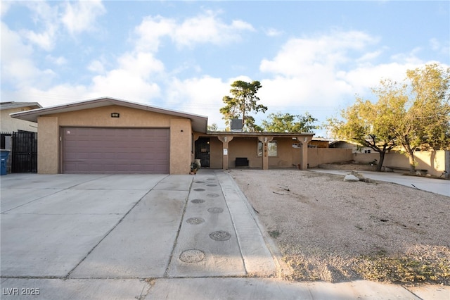 6608 Burgundy Way, Las Vegas, NV 89107 - ranch-style house with stucco siding, an attached garage, and concrete driveway