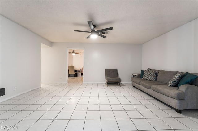6608 Burgundy Way, Las Vegas, NV 89107 - living area featuring a ceiling fan, light tile patterned floors, a textured ceiling, and baseboards
