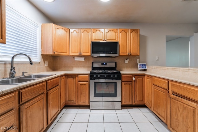 6608 Burgundy Way, Las Vegas, NV 89107 - kitchen with appliances with stainless steel finishes, a sink, backsplash, and light tile patterned floors