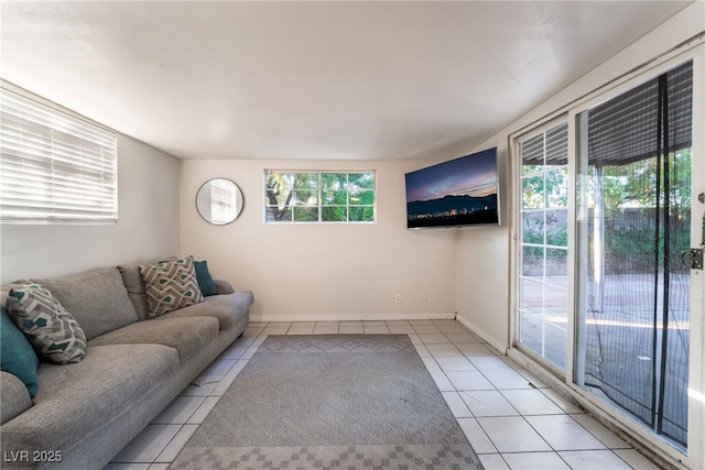 6608 Burgundy Way, Las Vegas, NV 89107 - unfurnished living room with tile patterned floors, healthy amount of natural light, and baseboards
