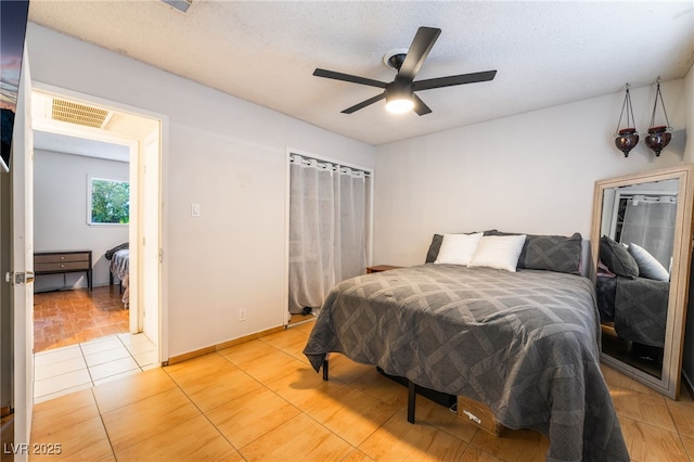 6608 Burgundy Way, Las Vegas, NV 89107 - bedroom with light tile patterned floors, a ceiling fan, and a textured ceiling