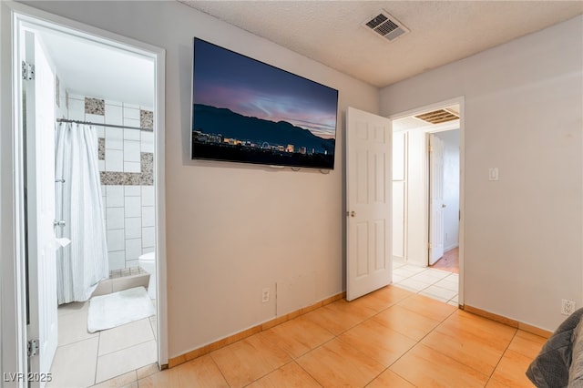 6608 Burgundy Way, Las Vegas, NV 89107 - unfurnished bedroom featuring tile patterned flooring, baseboards, and connected bathroom