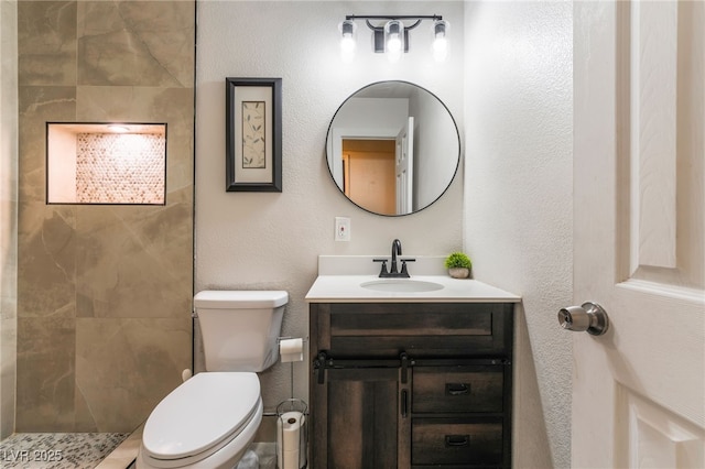 6608 Burgundy Way, Las Vegas, NV 89107 - bathroom with vanity, toilet, a tile shower, and a textured wall