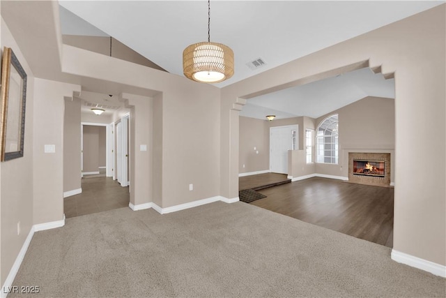 104 Hutton Ln, Las Vegas, NV 89145 - unfurnished living room featuring carpet flooring, lofted ceiling, baseboards, and a fireplace