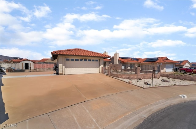 411 Monmouth Ct, Henderson, NV 89015 - mediterranean / spanish house with a fenced front yard, a gate, stucco siding, solar panels, and a tile roof