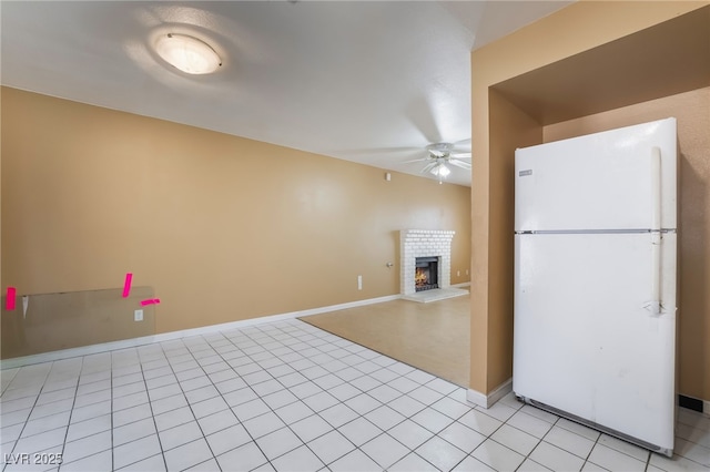 411 Monmouth Ct, Henderson, NV 89015 - kitchen featuring freestanding refrigerator, ceiling fan, a brick fireplace, baseboards, and light tile patterned floors