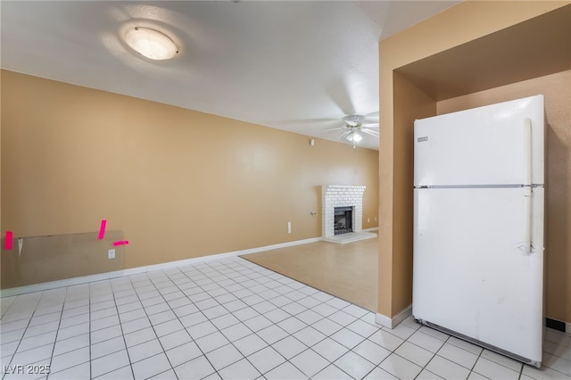 411 Monmouth Ct, Henderson, NV 89015 - kitchen with freestanding refrigerator, ceiling fan, a fireplace, baseboards, and light tile patterned flooring