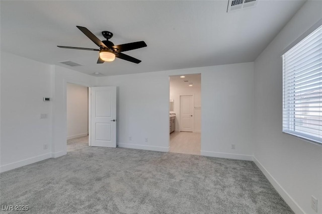 4633 Fragrant St, North Las Vegas, NV 89031 - unfurnished bedroom with light colored carpet, connected bathroom, baseboards, and a ceiling fan