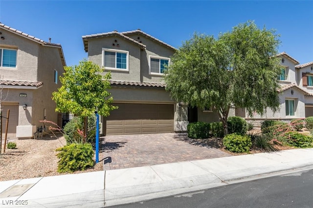 4633 Fragrant St, North Las Vegas, NV 89031 - view of front of property featuring an attached garage, stucco siding, driveway, and a tiled roof
