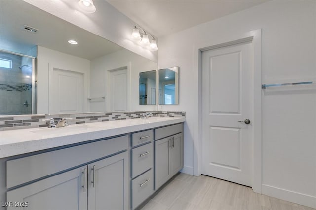 4633 Fragrant St, North Las Vegas, NV 89031 - full bath featuring double vanity, a stall shower, tasteful backsplash, and baseboards