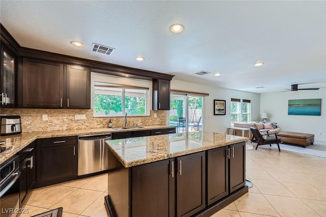 529 Caribbean Palm Dr, Las Vegas, NV 89138 - kitchen with stainless steel dishwasher, wall oven, a sink, tasteful backsplash, and recessed lighting