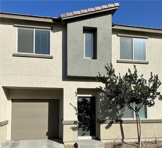 12170 Midnight Pine Rd Unit 3, Las Vegas, NV 89183 - view of front of house featuring stucco siding and an attached garage