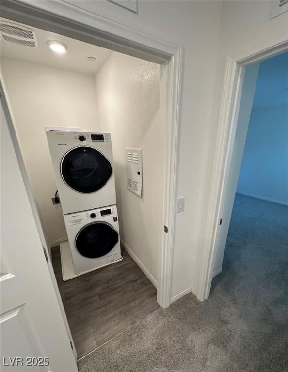 12170 Midnight Pine Rd Unit 3, Las Vegas, NV 89183 - laundry area with stacked washer / dryer and carpet floors