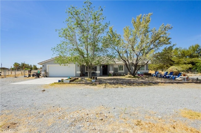 2251 Bridger St, Pahrump, NV 89048 - ranch-style home featuring an attached garage, stucco siding, and driveway