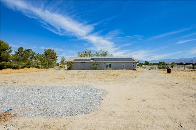 2251 Bridger St, Pahrump, NV 89048 - back of house featuring roof mounted solar panels and a mountain view