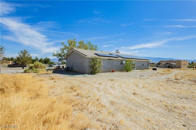 2251 Bridger St, Pahrump, NV 89048 - view of side of home featuring solar panels and stucco siding