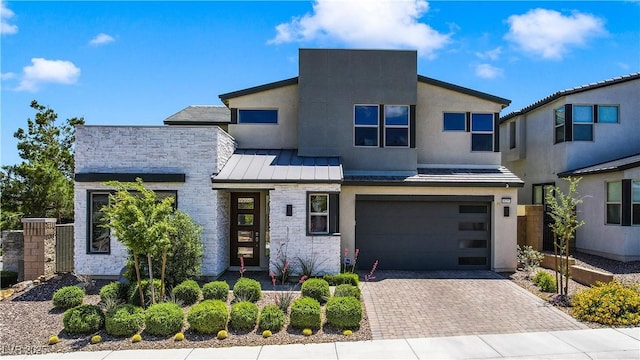 10297 Sierra Skye Ave, Las Vegas, NV 89166 - modern home with a garage, decorative driveway, a standing seam roof, metal roof, and stone siding