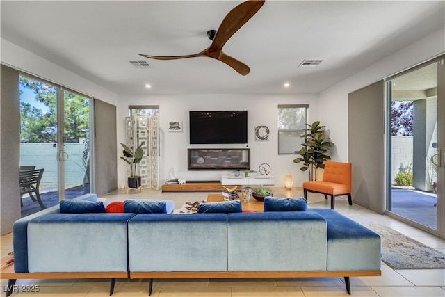 10297 Sierra Skye Ave, Las Vegas, NV 89166 - living room with healthy amount of natural light, ceiling fan, recessed lighting, and light tile patterned floors