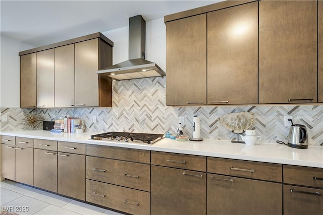 10297 Sierra Skye Ave, Las Vegas, NV 89166 - kitchen with wall chimney range hood, stainless steel gas stovetop, decorative backsplash, and light countertops
