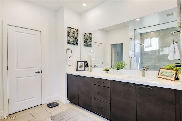 10297 Sierra Skye Ave, Las Vegas, NV 89166 - bathroom featuring double vanity, a shower stall, tile patterned floors, and baseboards