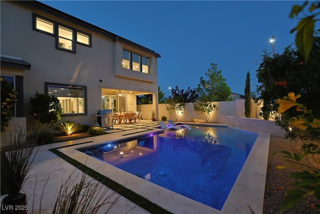 10297 Sierra Skye Ave, Las Vegas, NV 89166 - pool at night with a patio and a fenced backyard