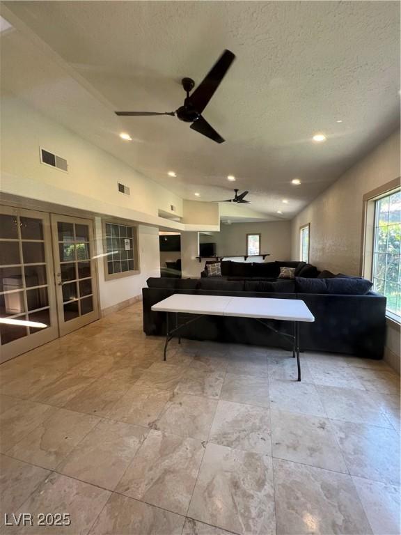 5260 Mission Monterey Ln Unit 208, Las Vegas, NV 89107 - living room featuring a ceiling fan, a textured ceiling, lofted ceiling, and recessed lighting
