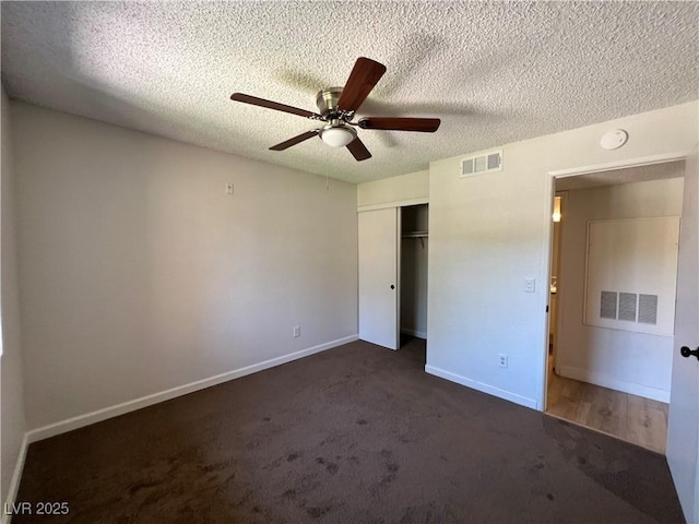 5260 Mission Monterey Ln Unit 208, Las Vegas, NV 89107 - unfurnished bedroom with a closet, dark carpet, a textured ceiling, baseboards, and a ceiling fan