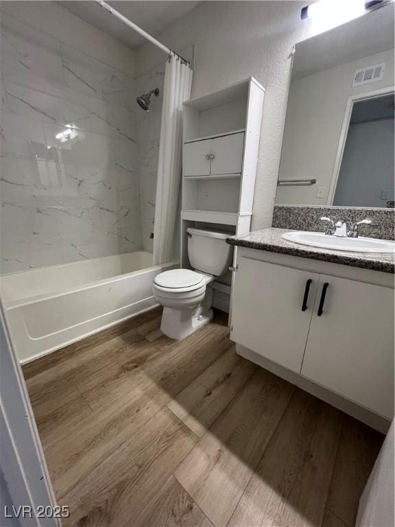5260 Mission Monterey Ln Unit 208, Las Vegas, NV 89107 - full bathroom featuring vanity, wood finished floors, toilet, and shower / bath combo