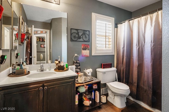 8884 Perfect Diamond Ct, Las Vegas, NV 89129 - full bathroom with vanity, toilet, wood finished floors, a textured wall, and a shower with shower curtain