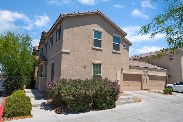 4610 Lime Straight Dr, Las Vegas, NV 89115 - view of side of property with stucco siding, concrete driveway, and a tiled roof