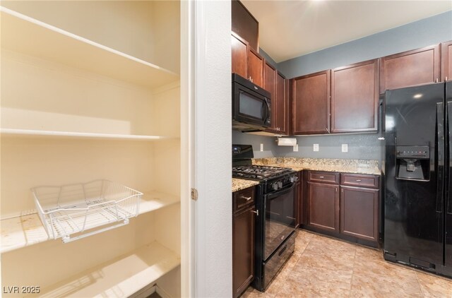 4610 Lime Straight Dr, Las Vegas, NV 89115 - kitchen featuring black appliances, light stone counters, and dark brown cabinetry