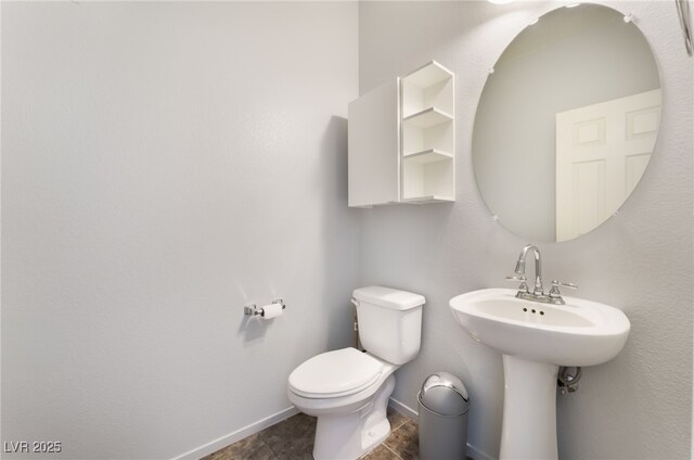 4610 Lime Straight Dr, Las Vegas, NV 89115 - half bath featuring baseboards, toilet, and a sink