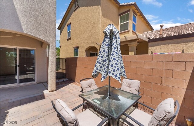 4610 Lime Straight Dr, Las Vegas, NV 89115 - view of patio featuring outdoor dining area and a gate
