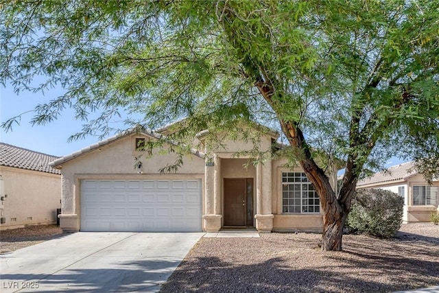 2410 Morocco Ave, North Las Vegas, NV 89031 - view of front of home with concrete driveway, an attached garage, and stucco siding