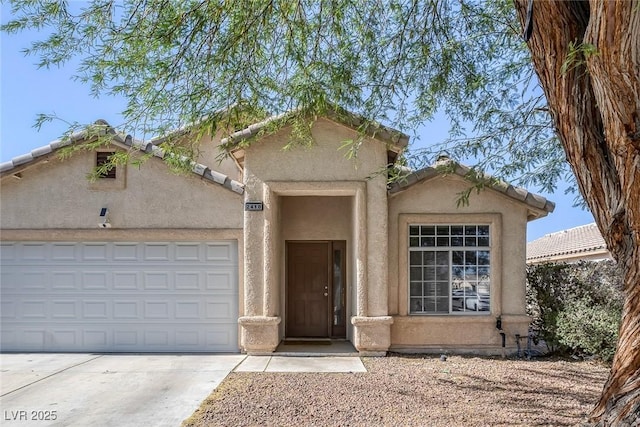 2410 Morocco Ave, North Las Vegas, NV 89031 - view of front of property featuring concrete driveway, a garage, and stucco siding