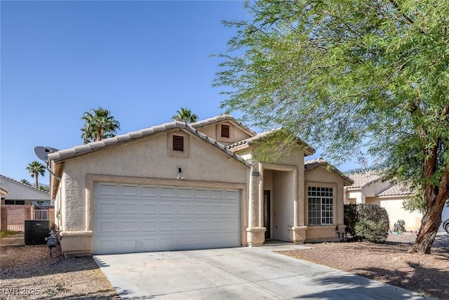 2410 Morocco Ave, North Las Vegas, NV 89031 - mediterranean / spanish-style home with driveway, a garage, stucco siding, and a tile roof