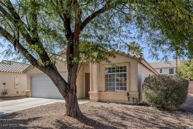 2410 Morocco Ave, North Las Vegas, NV 89031 - view of front of property featuring stucco siding, concrete driveway, an attached garage, and a tiled roof