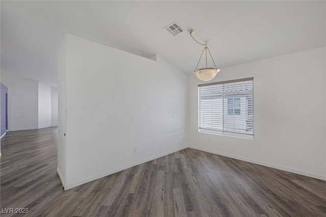 2410 Morocco Ave, North Las Vegas, NV 89031 - empty room with wood finished floors, baseboards, and vaulted ceiling