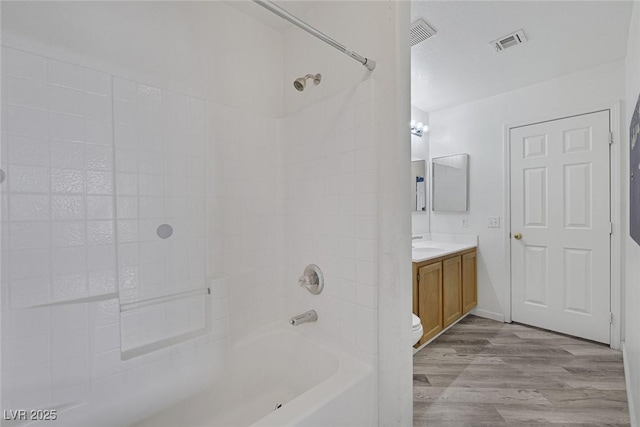 2410 Morocco Ave, North Las Vegas, NV 89031 - bathroom featuring wood finished floors, vanity, shower / bath combination, and toilet