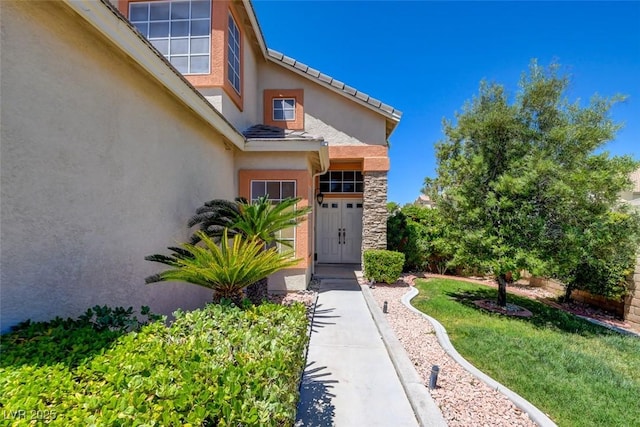 4835 Willow Glen Dr, Las Vegas, NV 89147 - property entrance featuring stucco siding, a yard, and stone siding