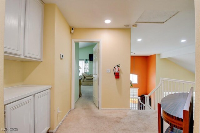 4835 Willow Glen Dr, Las Vegas, NV 89147 - hallway featuring light carpet, an upstairs landing, vaulted ceiling, recessed lighting, and baseboards