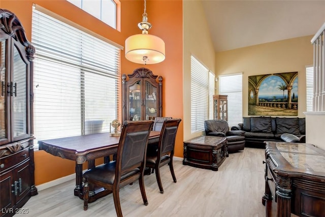 4835 Willow Glen Dr, Las Vegas, NV 89147 - dining area featuring light wood-type flooring, baseboards, and high vaulted ceiling