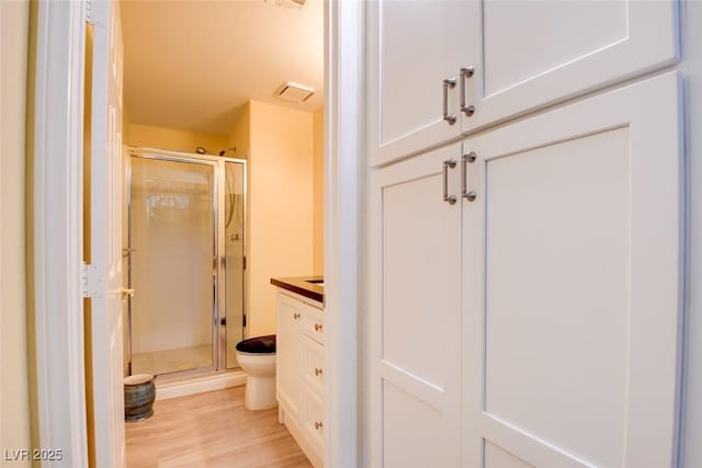 4835 Willow Glen Dr, Las Vegas, NV 89147 - bathroom with toilet, a shower stall, wood finished floors, and vanity
