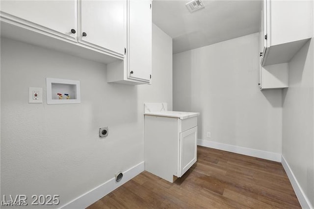 728 Carpenter Dr, Las Vegas, NV 89107 - washroom with washer hookup, cabinet space, dark wood-type flooring, baseboards, and electric dryer hookup