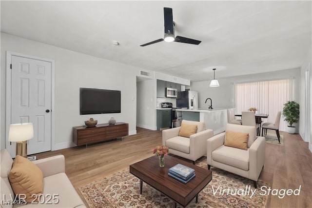728 Carpenter Dr, Las Vegas, NV 89107 - living room with light wood-style flooring and ceiling fan