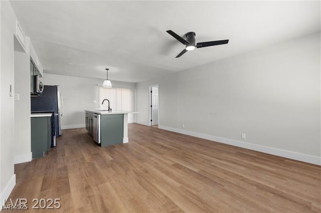 728 Carpenter Dr, Las Vegas, NV 89107 - unfurnished living room featuring a sink, a ceiling fan, wood finished floors, and baseboards