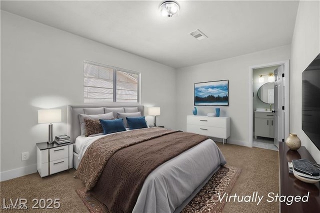 728 Carpenter Dr, Las Vegas, NV 89107 - bedroom with light carpet, baseboards, and ensuite bathroom
