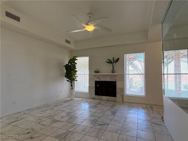 5600 Grossmont Ave, Las Vegas, NV 89110 - unfurnished living room featuring ceiling fan, plenty of natural light, and a fireplace